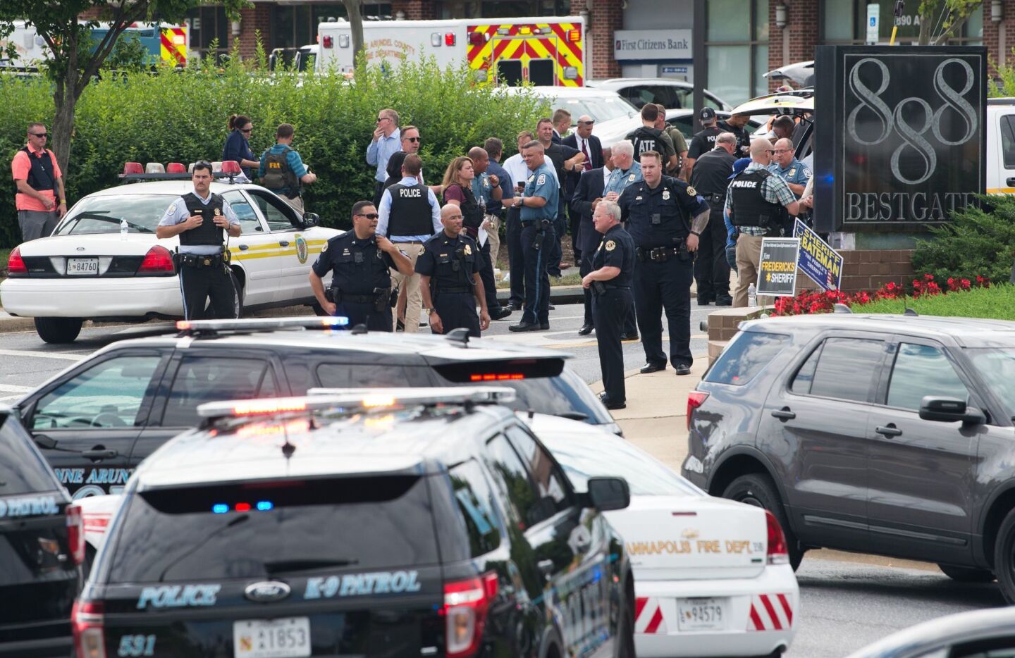 Law enforcement officers respond to a shooting at the Capital, a daily newspaper in Annapolis, Md., that killed five.