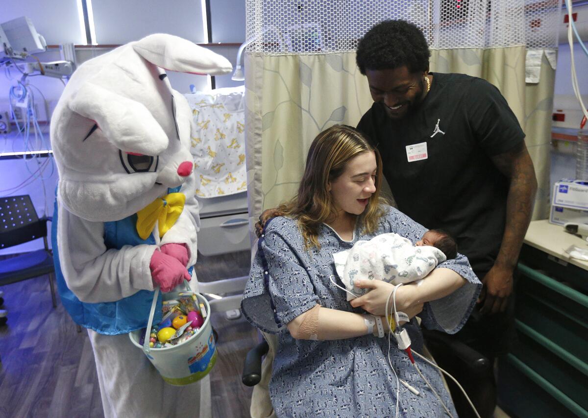 Vanessa and Darwin Jones with newborn Arai and the Easter Bunny at Fountain Valley Regional Hospital.