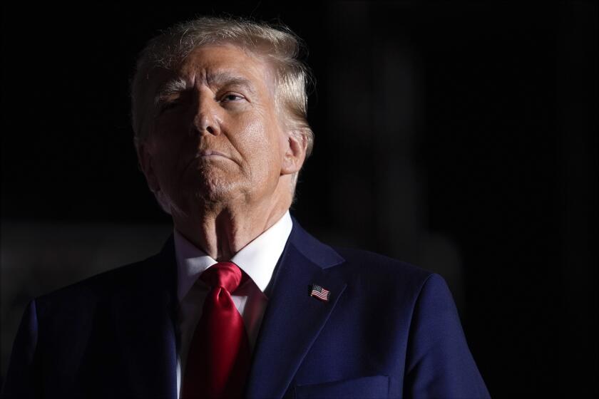 Republican presidential nominee former President Donald Trump listens to opera singer Christopher Macchio after speaking at a campaign rally at the Butler Farm Show, Saturday, Oct. 5, 2024, in Butler, Pa. (AP Photo/Evan Vucci)