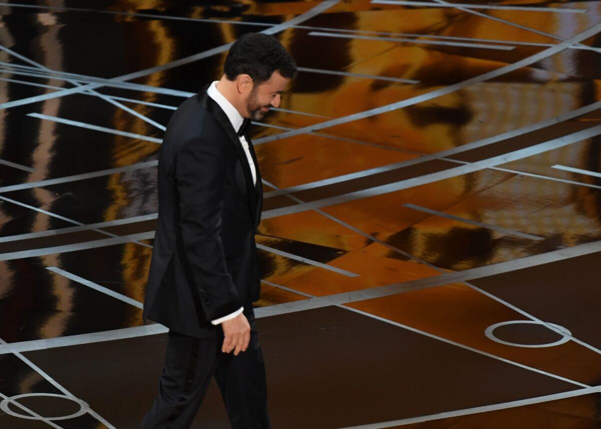 Jimmy Kimmel walks off the Oscars stage at the end of the telecast.