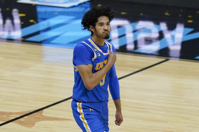 UCLA guard Johnny Juzang reacts after making a basket during the first half of a men's Final Four NCAA college basketball tournament semifinal game against Gonzaga, Saturday, April 3, 2021, at Lucas Oil Stadium in Indianapolis. (AP Photo/Darron Cummings)