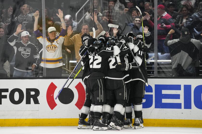 The Los Angeles Kings celebrate after right wing Adrian Kempe scored during overtime of an NHL hockey game against the Chicago Blackhawks Thursday, April 18, 2024, in Los Angeles. The Kings won 5-4. (AP Photo/Ashley Landis)