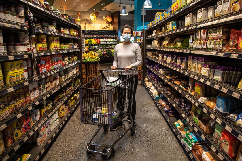 SAN DIEGO, CA - NOVEMBER 19: Stephanie Nguyen goes food shopping ahead of the Thanksgiving holiday at Baron's Market in North Park on Thursday, Nov. 19, 2020 in San Diego, CA. (Jarrod Valliere / The San Diego Union-Tribune)