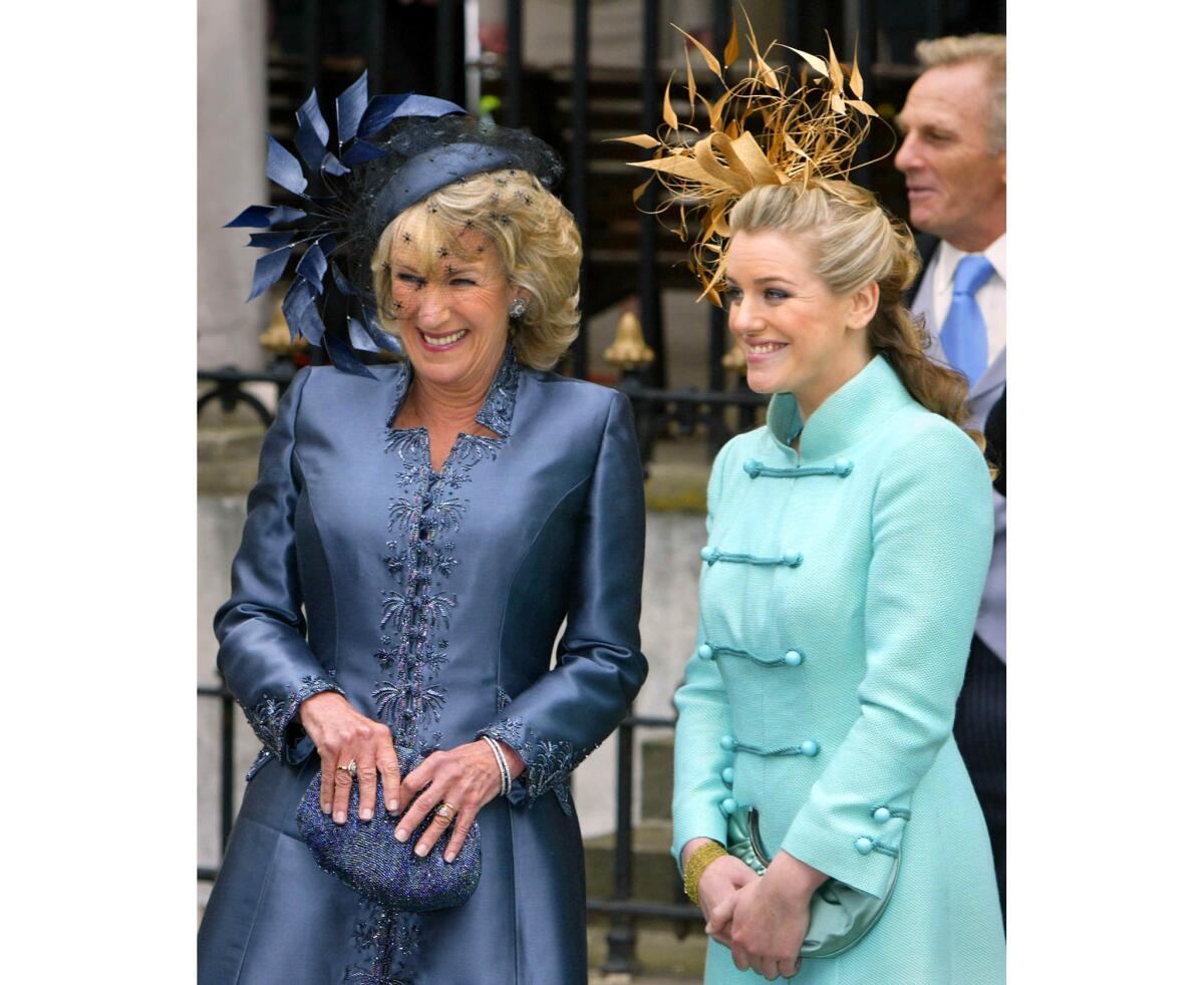 April 9, 2005: Camilla Parker Bowles' sister Annabel Elliot, left, and daughter Laura Parker Bowles watch as the royal party drives away from the Guildhall after the civil ceremony.