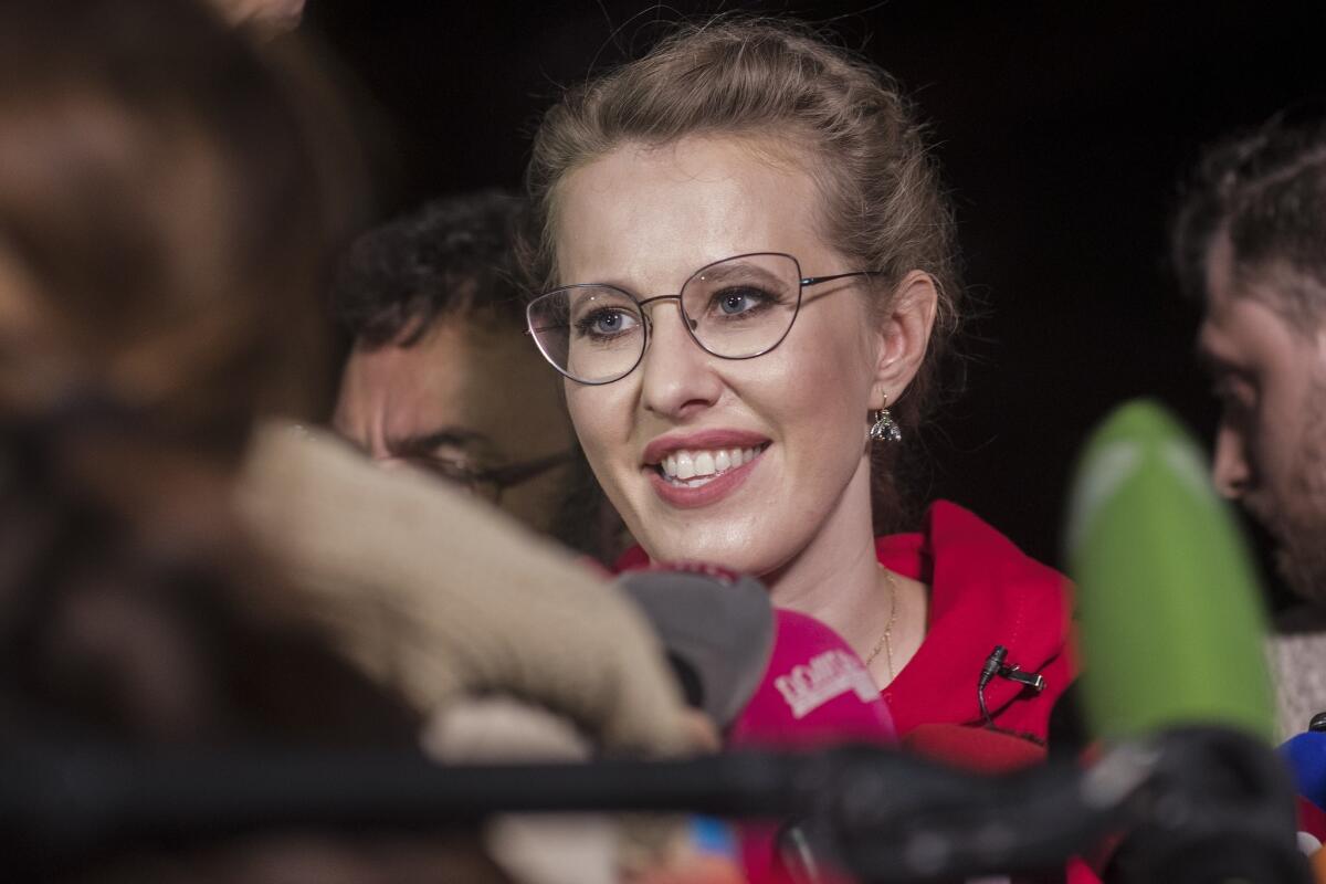 Presidential opposition candidate and former reality TV star Ksenia Sobchak speaks to reporters in Moscow on Thursday after a rally in which she declared her intention to create a new liberal party in Russia.