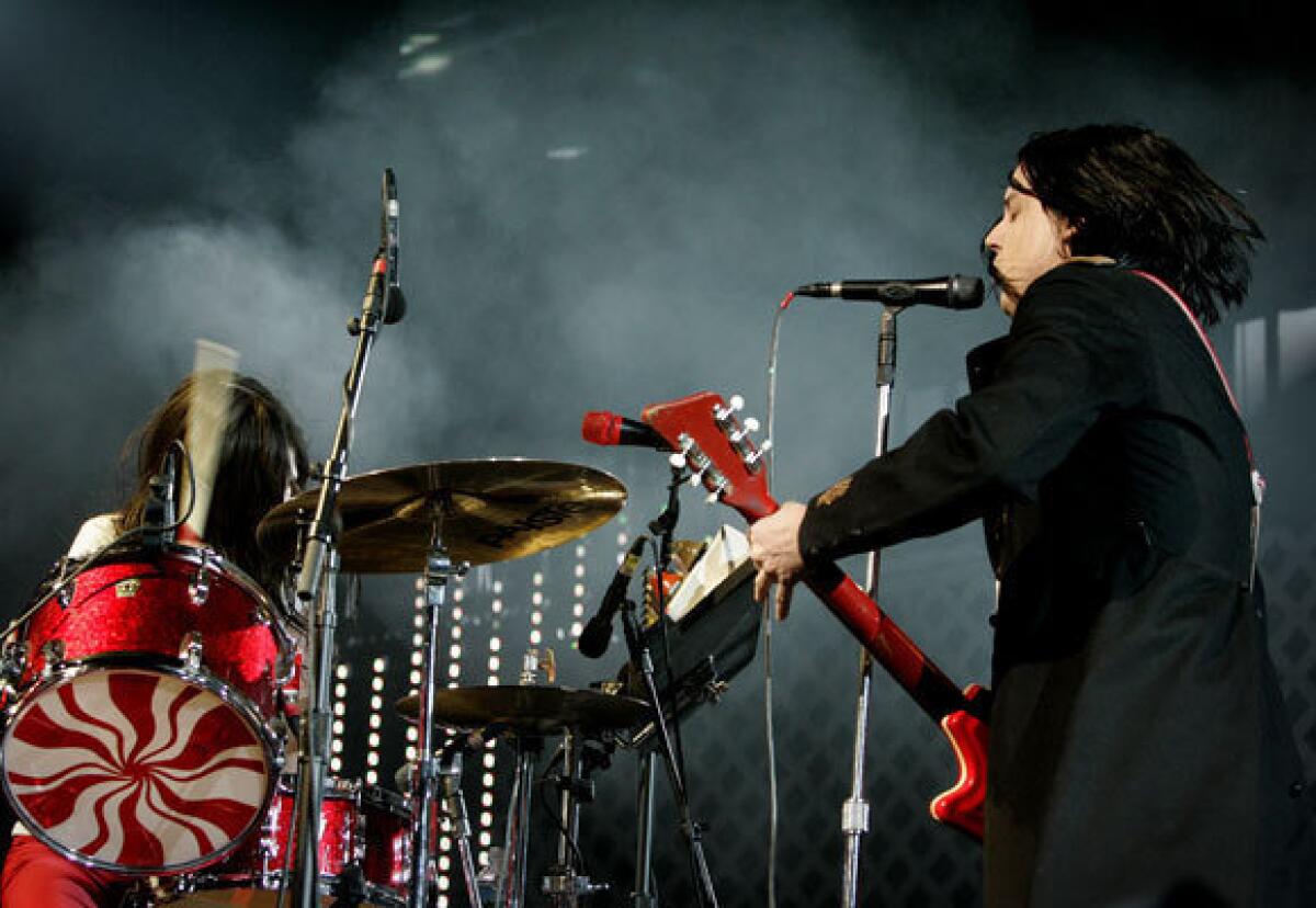 The White Stripes -- Meg and Jack White -- perform at the KROQ Almost Acoustic Christmas concert at the Gibson Amphitheatre at Universal City Walk on Dec. 11, 2005.