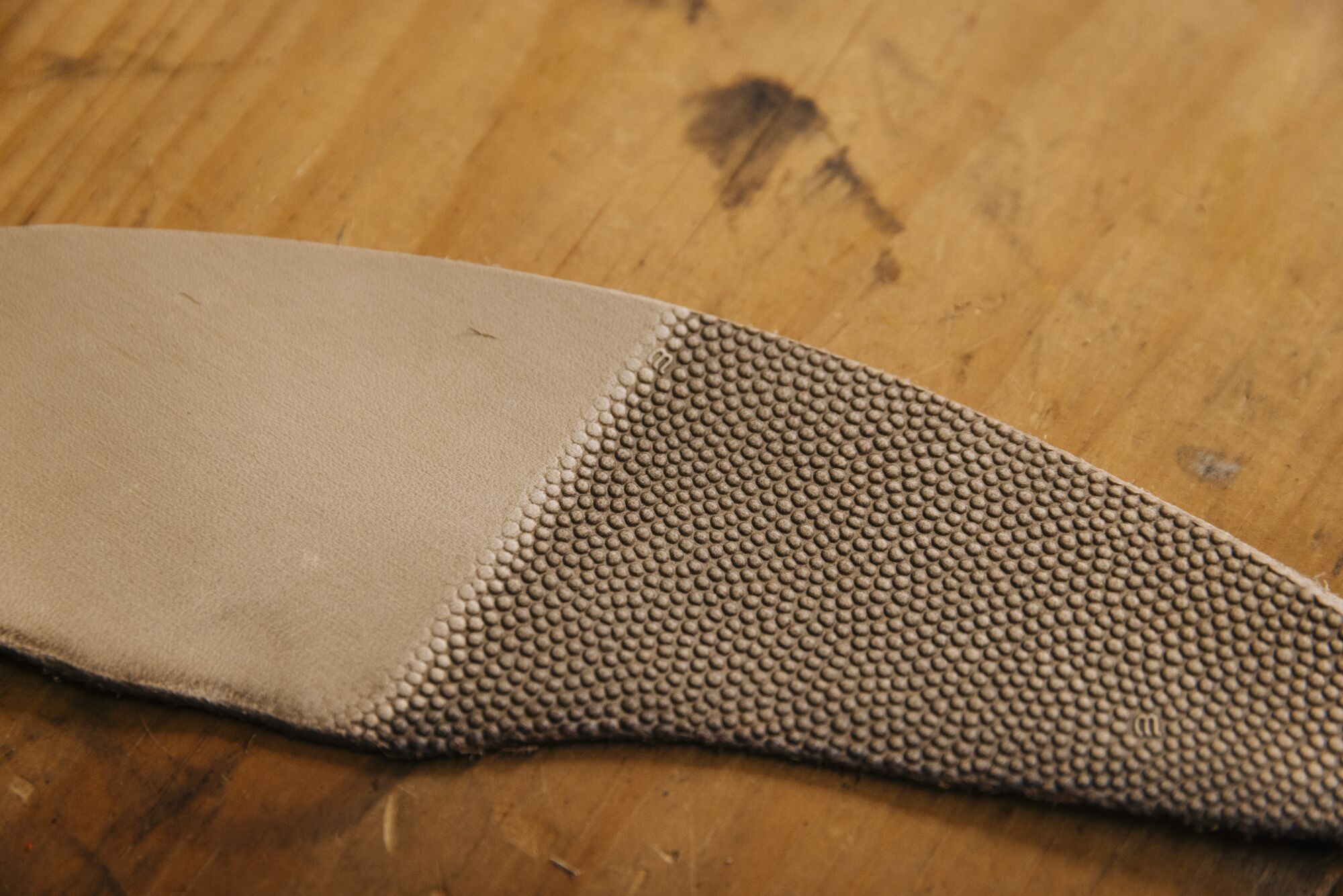 A half embossed piece of leather with dimpling.