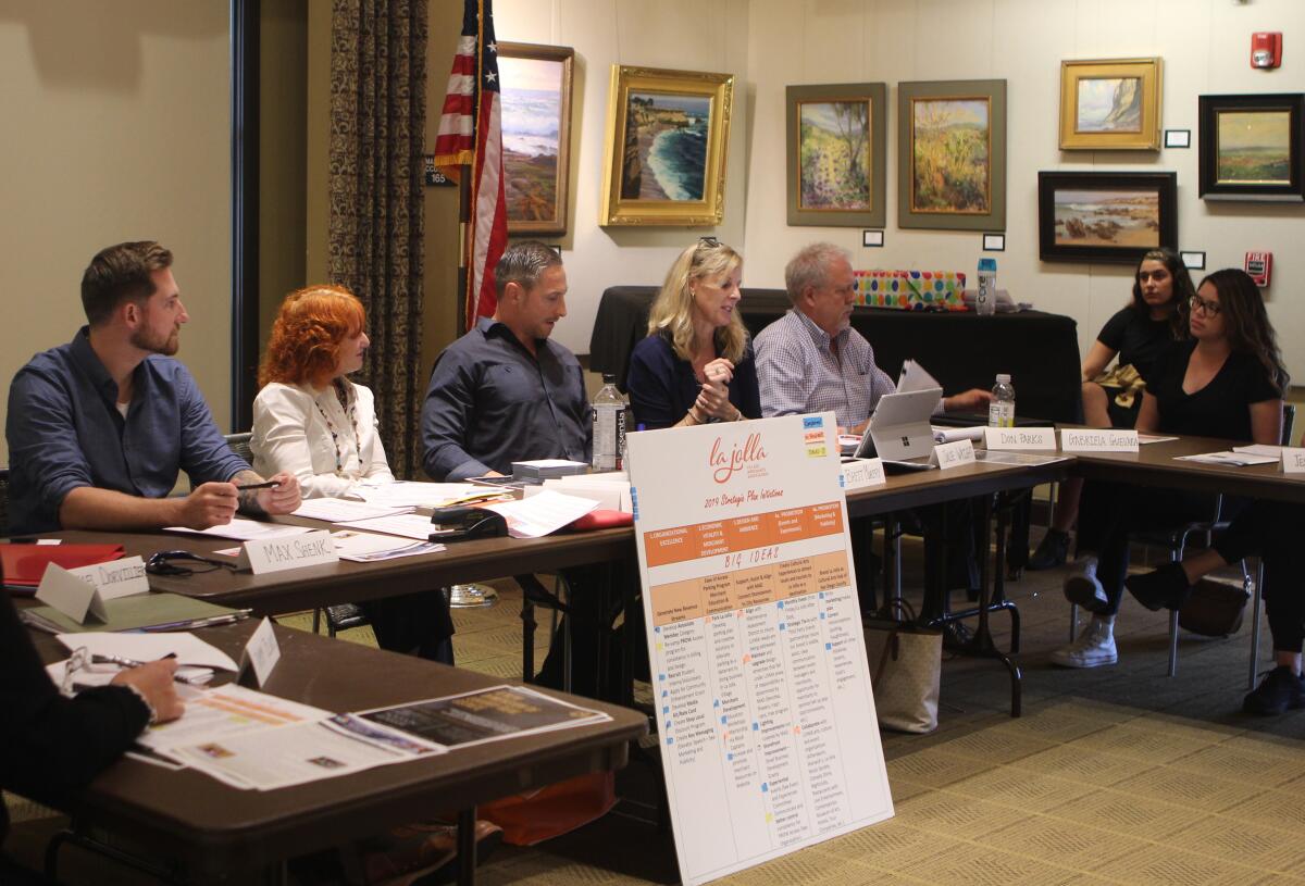 The La Jolla Village Merchants Association (pictured from left: Max Shenk, Jodi Rudick, Brett Murphy, Julie Wright, Don Parks and Gabriela Guevara) announces its newly elected board members on Oct. 9 at the La Jolla Riford Library.