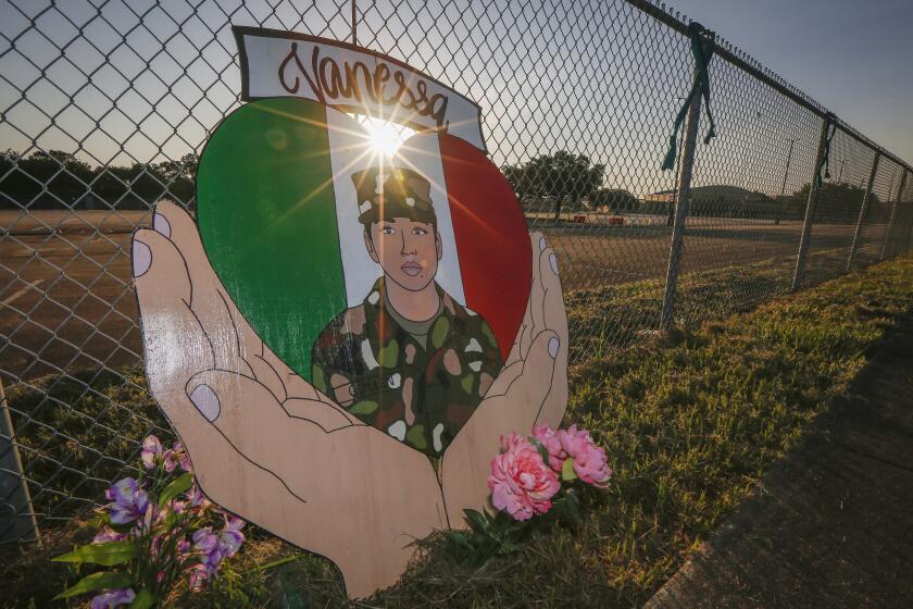 A small memorial for U.S. Army Specialist Vanessa Guillen is set up around Cesar Chavez High School Friday, Aug. 14, 2020, in Houston. Investigators said Guillen was bludgeoned to death on base by a fellow soldier, who later killed himself. (Steve Gonzales/Houston Chronicle via AP)