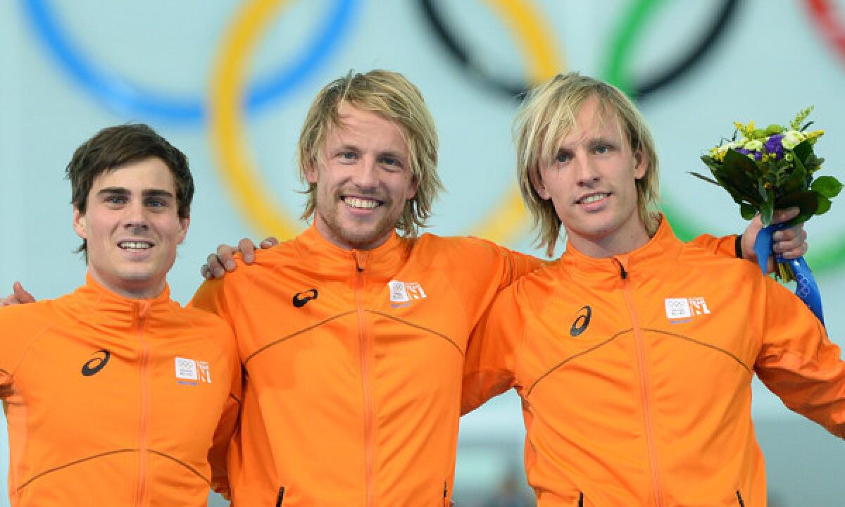 Silver medalist Jan Smeekens, left, gold medalist Michel Mulder, center, and bronze medalist Ronald Mulder celebrate their podium sweep for the Netherlands in the men's 500-meter speedskating competition at the 2014 Sochi Winter Olympic Games on Monday.