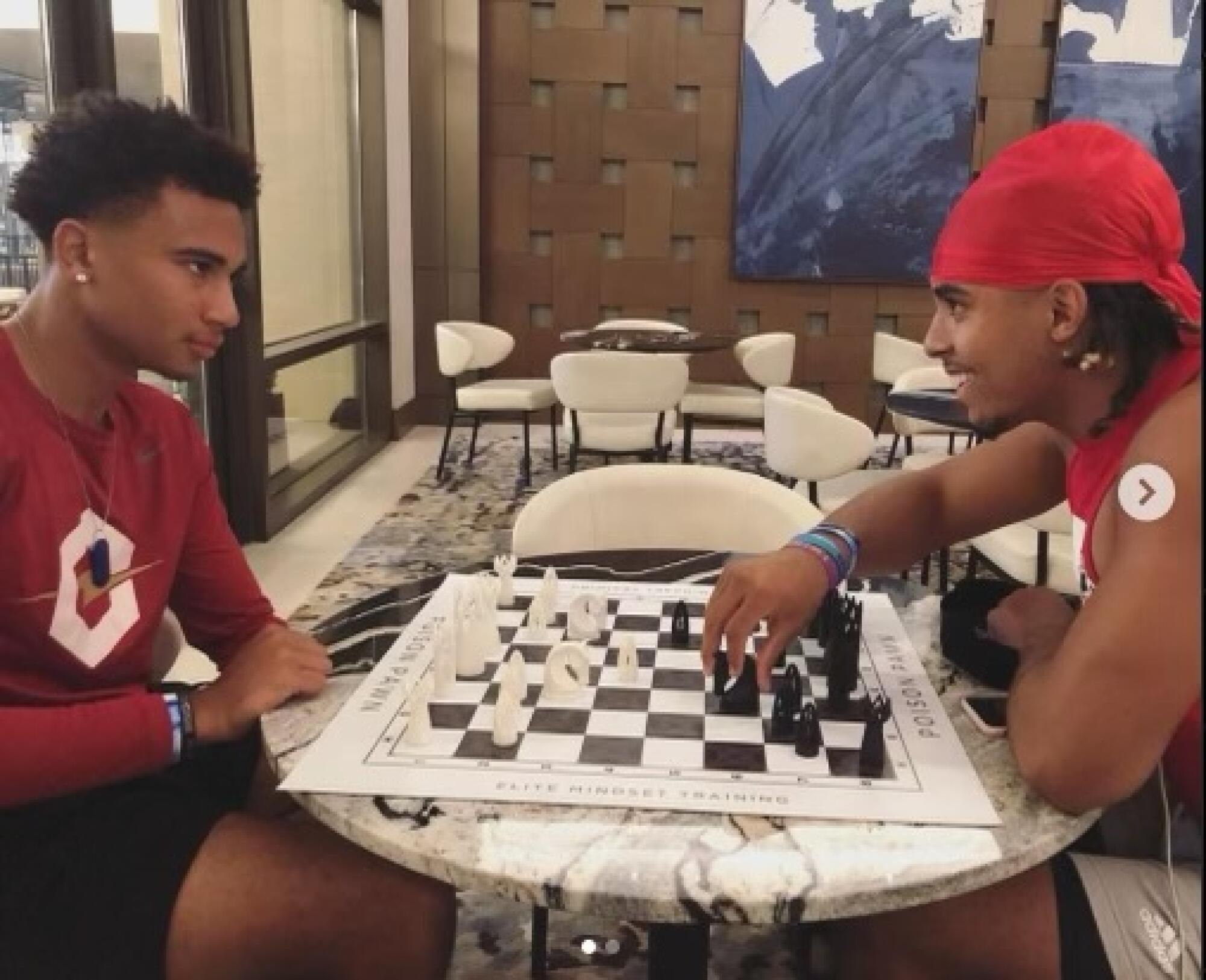 C.J. Stroud, left, current quarterback for the Houston Texans, plays chess with Gee Scott Jr. when they were at Ohio State.