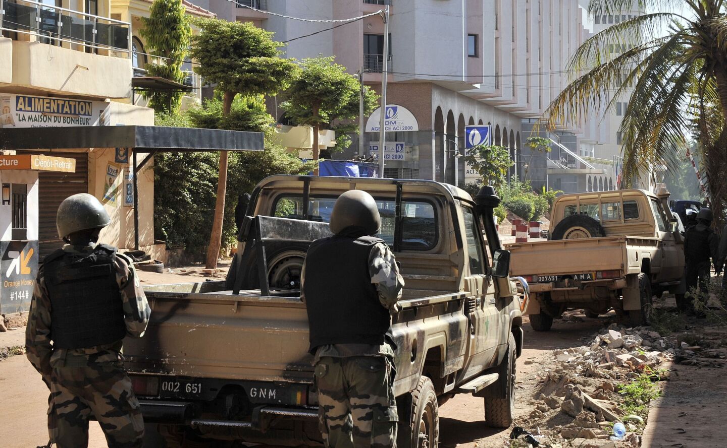 Malian troops take positions outside the Radisson Blu hotel in Bamako.