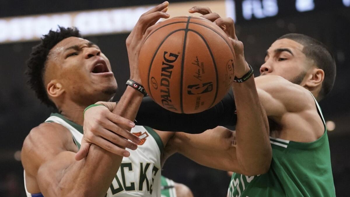 Milwaukee Bucks' Giannis Antetokounmpo is fouled by Boston Celtics' Jayson Tatum during the first half of Game 5 of a second round NBA playoff series on Wednesday in Milwaukee.