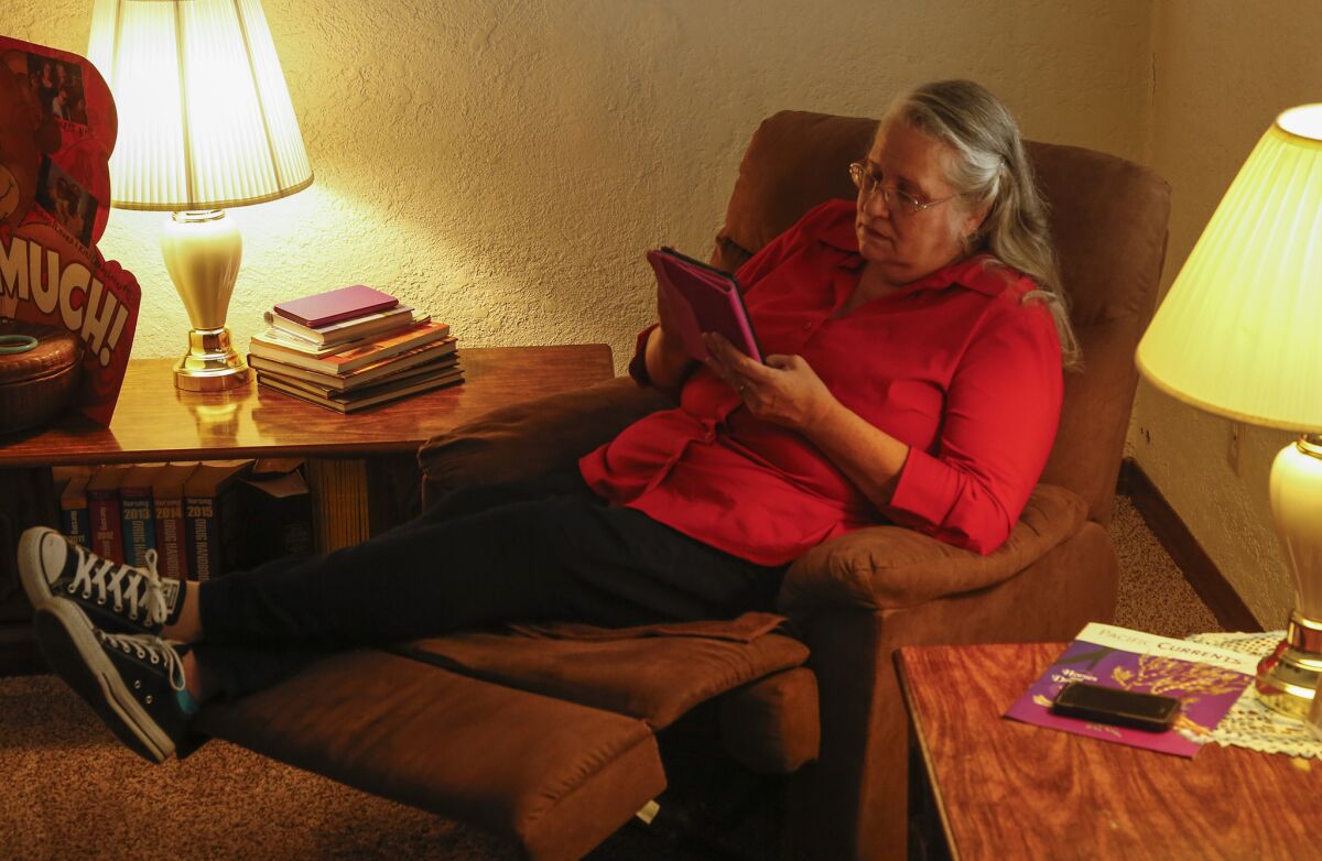 When she isn't being the caregiver for her mother, Long Beach resident Cheri Brown spends her spare time using the coloring app, Recolor on her iPad Mini. (Mark Boster / Los Angeles Times)