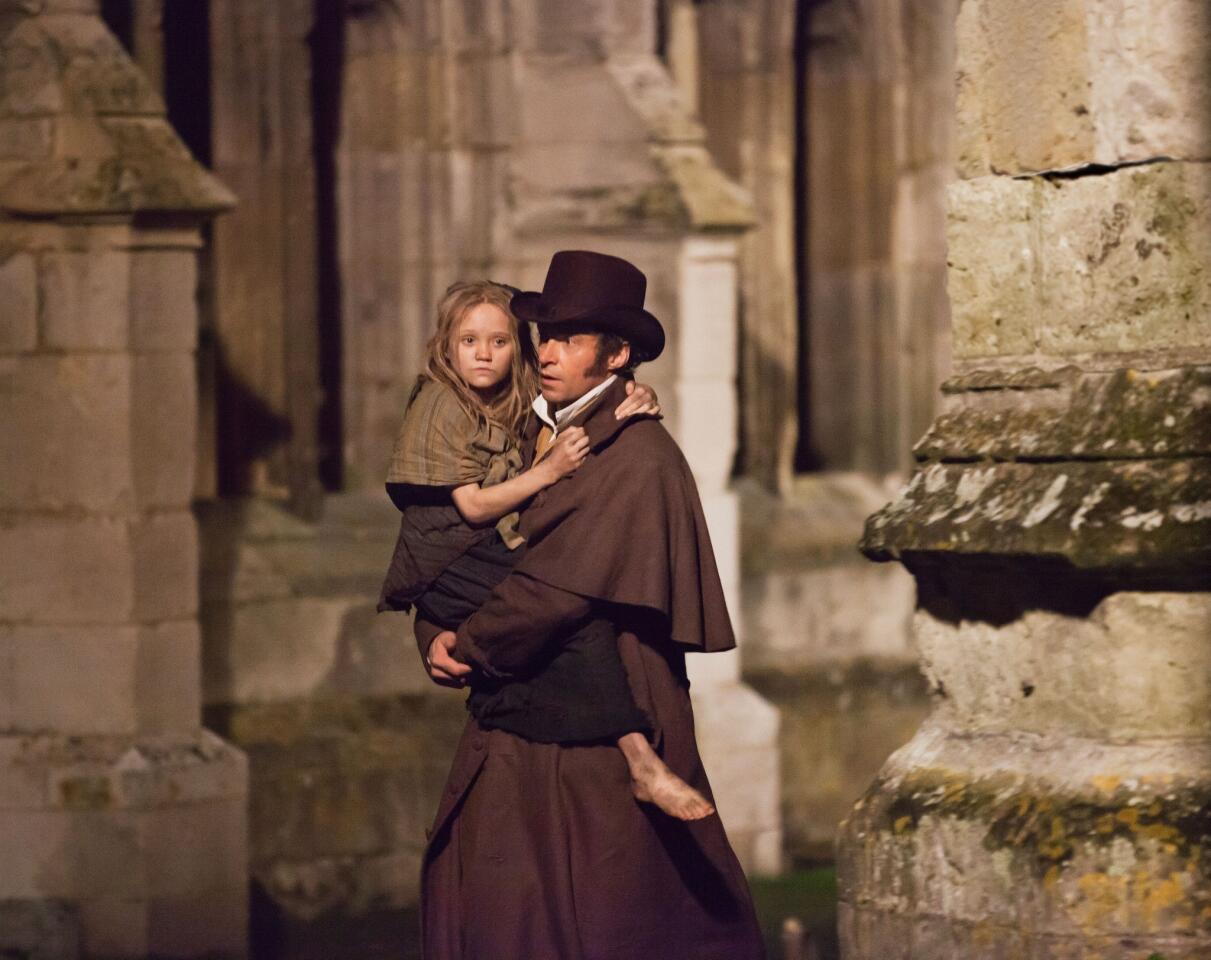 Isabelle Allen, as a young Cosette, and Hugh Jackman as Jean Valjean in a scene from the motion-picture adaptation of "Les Misérables."