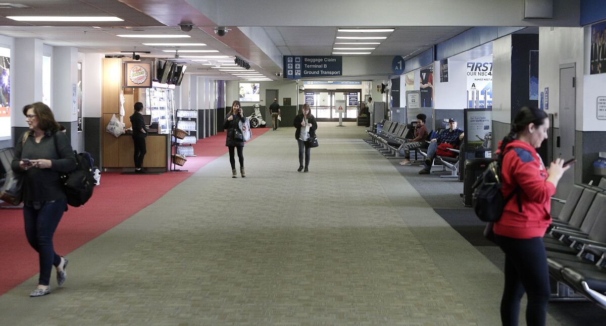 Only a few passengers are in the hall at the Hollywood Burbank Airport on Tuesday, March 17.