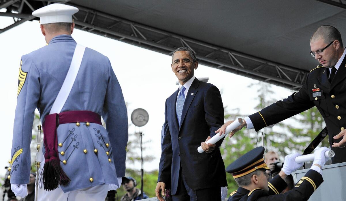 President Obama hands out diplomas to the graduating class of the U.S. Military Academy at West Point, where his commencement speech addressed criticism of his foreign policy strategy.