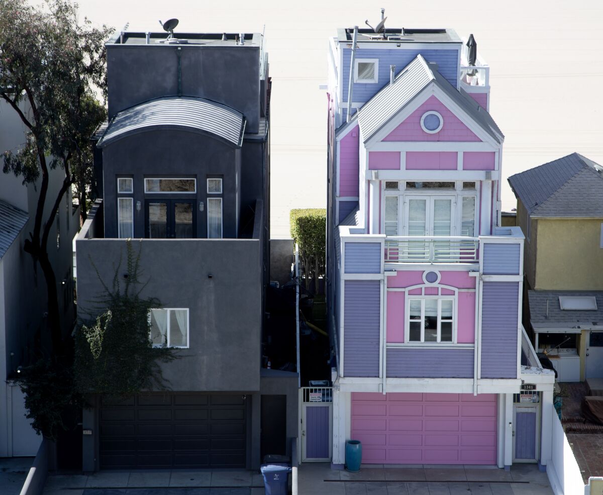 Two houses: the Barbie House, pink and purple, right, and the all-black house 