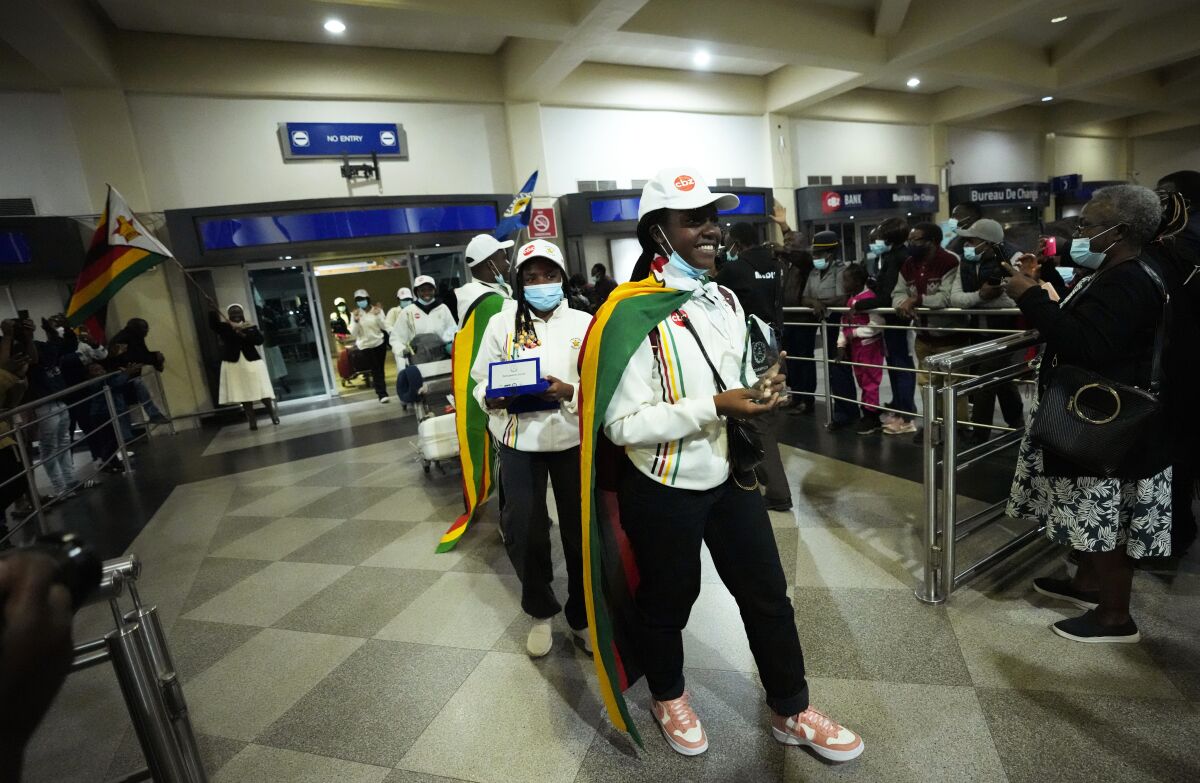 Zimbabwean high school World and European moot court competition champions arrive back at the Robert Mugabe International airport in Harare, Thursday, July, 7, 2022. A history-making team of Zimbabwean high school students that became world and European moot court competition champions has been widely praised in a country where the education system is beset by poor funding, lack of materials and teachers’ strikes. (AP Photo/Tsvangirayi Mukwazhi)