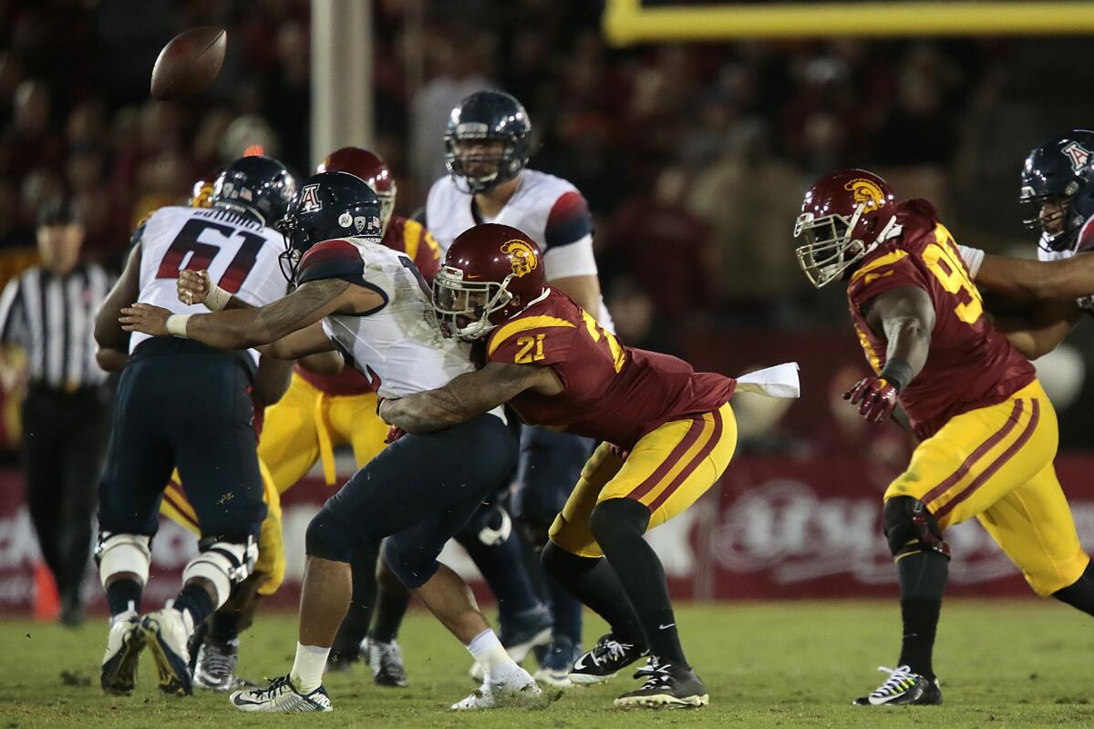 USC linebacker Su'a Cravens causes Arizona quarterback Anu Solomon to fumble during the fourth quarter of the Trojans' 38-30 win over the Wildcats last Saturday.