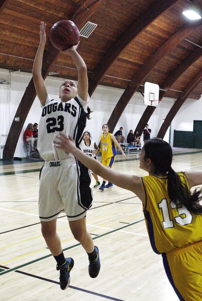 Glendale Adventist Academy's Madi Federici takes a jump shot under the basket against Holy Martyrs' Galy Kuyumjian at GAA on Thursday, January 16, 2014. (Tim Berger/Staff Photographer)