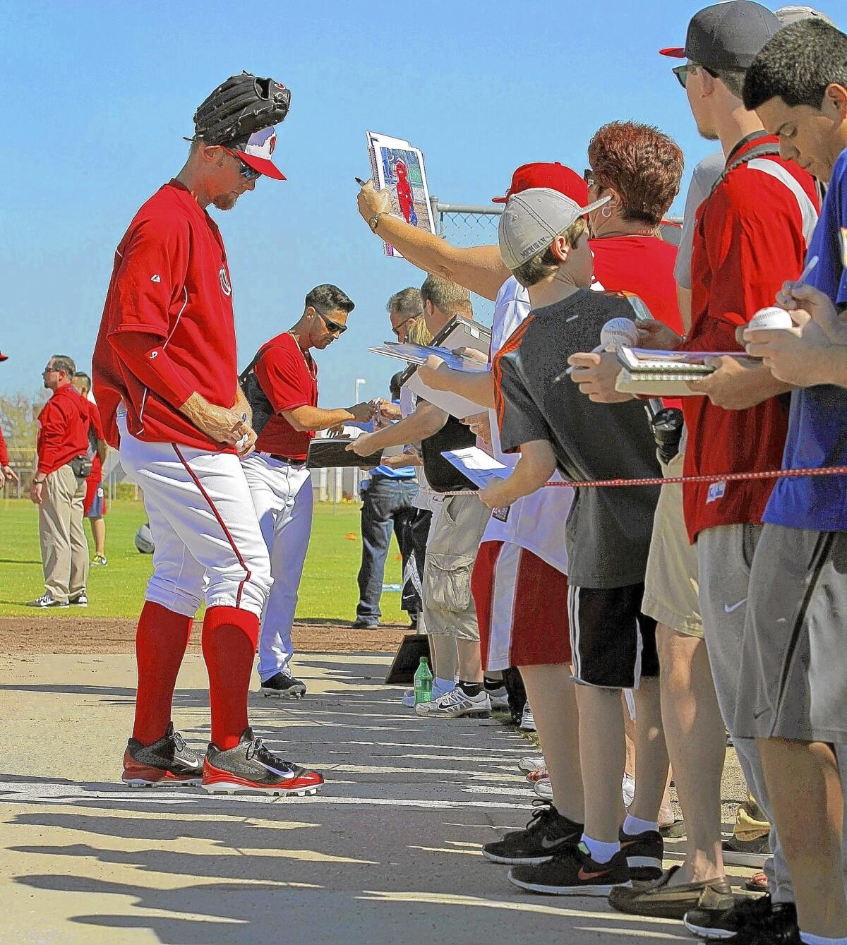Stephen Strasburg, left, and Nationals teammate Gio Gonzalez in 2014 with fans in Viera, Fla.