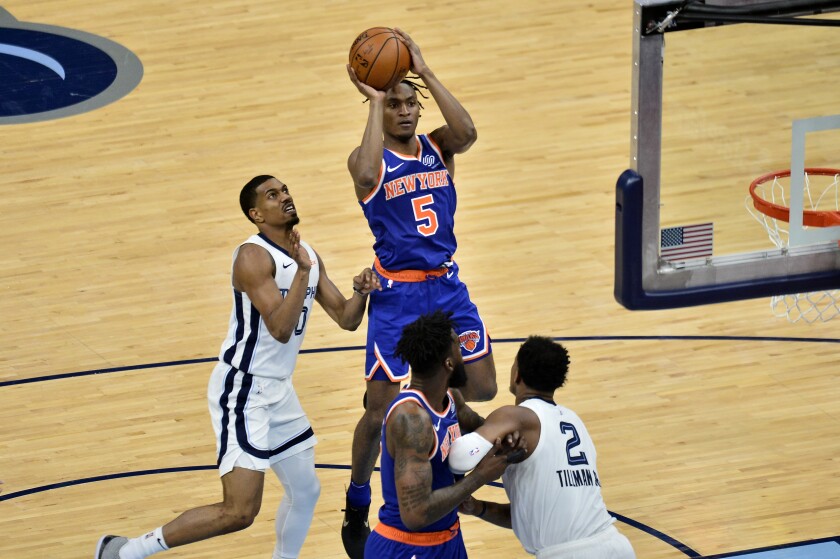New York Knicks guard Immanuel Quickley (5) shoots ahead of Memphis Grizzlies guard De'Anthony Melton (0) in the second half of an NBA basketball game Monday, May 3, 2021, in Memphis, Tenn. (AP Photo/Brandon Dill)