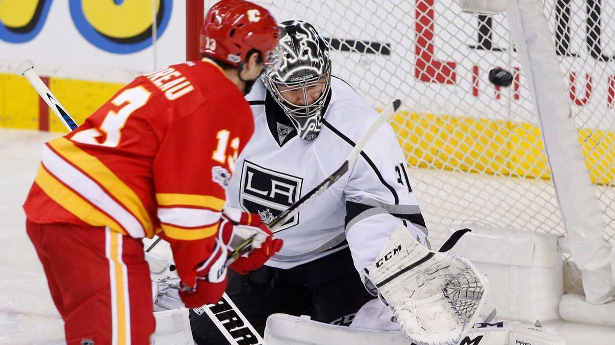 Kings goalie Ben Bishop, right, gives up a goal to Calgary Flames' Johnny Gaudreau during the second period Sunday.