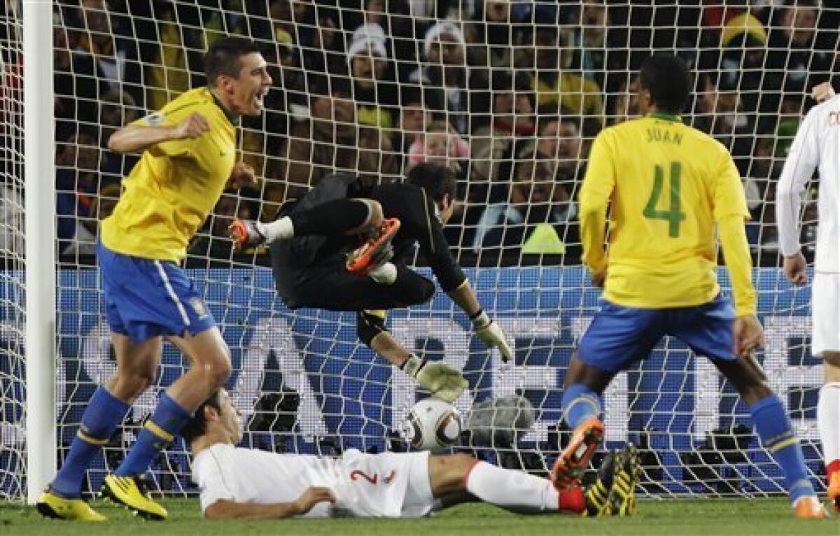 Brazil's Lucio and Robinho battles Chile's Humberto Suazo during the 2010  FIFA World Cup South Africa 1/8 of final Soccer match, Brazil vs Chile at  Ellis Park football stadium in Johannesburg, South