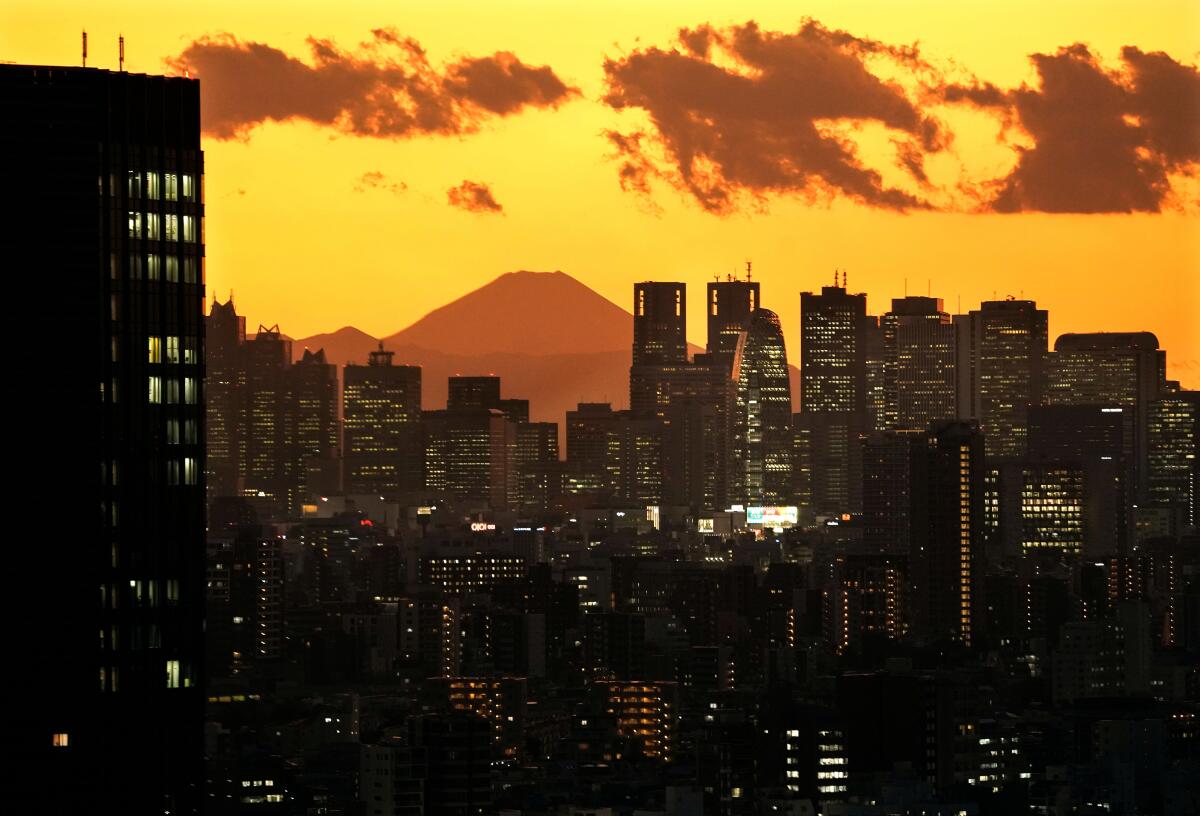 Mt. Fuji, Japan's tallest peak, as seen through Shinjuku skyscrapers. Japanese passport holders can access 191 countries without a visa.