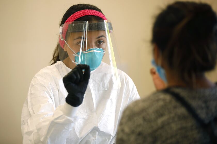SAN MARCOS, CA - NOVEMBER 16: Vivianna Hernandez monitors a Covid-19 test at Cal State University San Marcos, one of the busiest testing centers in San Diego County on Monday, Nov. 16, 2020 in San Marcos, CA. (K.C. Alfred / The San Diego Union-Tribune)