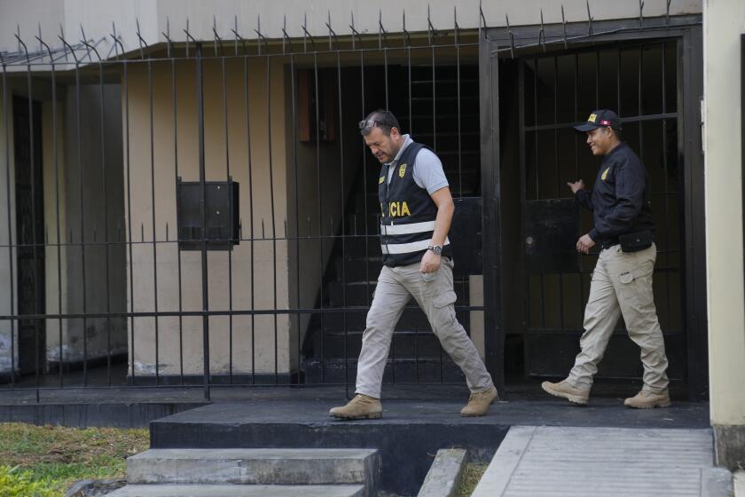 Police officers leave the home of Nicanor Boluarte, the brother of Peruvian President Dina Boluarte, in Lima, Peru, Friday, May 10, 2024. Prosecutors arrested the president's brother for allegedly being part of a group that trafficked influence by appointing officials in exchange for money and forcing them to collect signatures to register a political party, according to the Attorney General’s Office. (AP Photo/Martin Mejia)