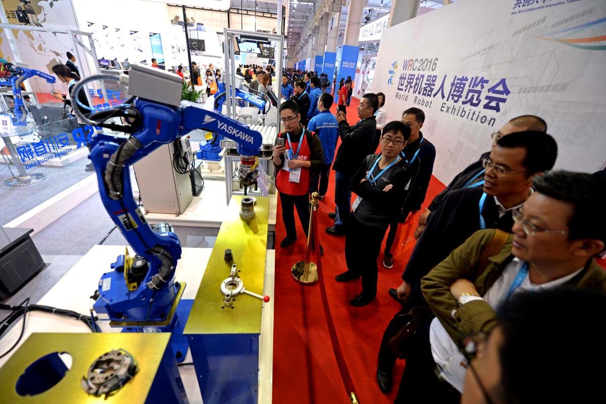 A Yaskawa robot performs at the 2016 World Robot Conference in Beijing.