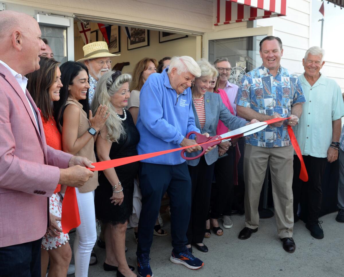 Bernie Svalstad cuts ribbon during the grand opening of its museum at the Balboa Fun Zone 