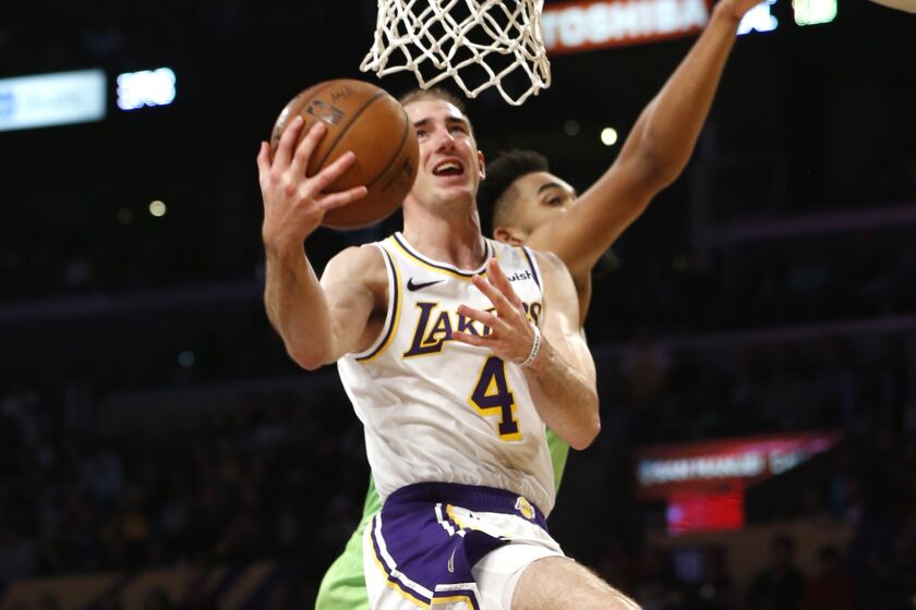 LOS ANGELES, CALIFORNIA - DECEMBER 08: Alex Caruso #4 of the Los Angeles Lakers goes up for a shot as Karl-Anthony Towns #32 of the Minnesota Timberwolves defends during the second half at Staples Center on December 08, 2019 in Los Angeles, California. NOTE TO USER: User expressly acknowledges and agrees that, by downloading and or using this photograph, User is consenting to the terms and conditions of the Getty Images License Agreement. (Photo by Katharine Lotze/Getty Images)