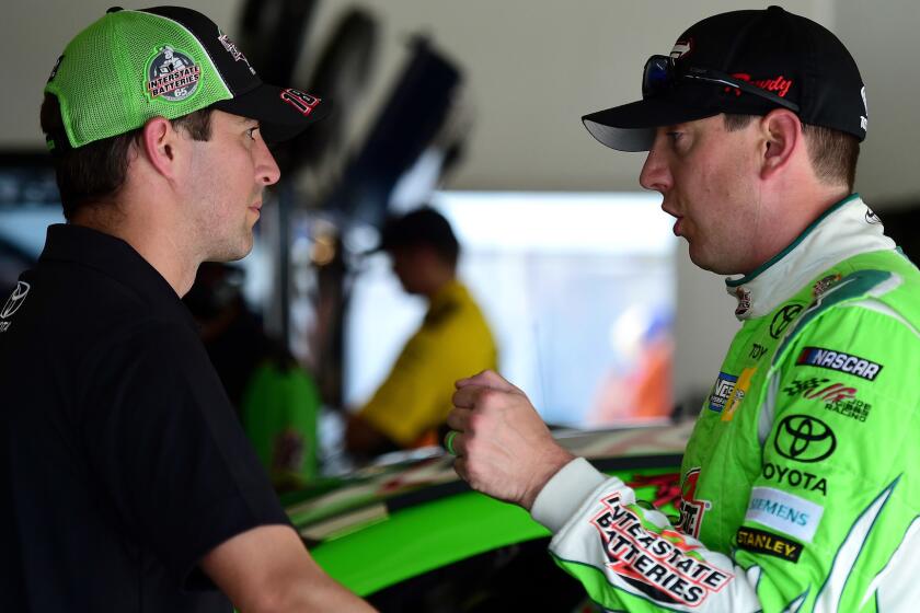 DAYTONA BEACH, FL - JUNE 29: Kyle Busch (R), driver of the #18 Interstate Batteries Toyota, talks with his interim crew chief Jacob Canter in the garage area during practice for the Monster Energy NASCAR Cup Series 59th Annual Coke Zero 400 Powered By Coca-Cola at Daytona International Speedway on June 29, 2017 in Daytona Beach, Florida. (Photo by Jared C. Tilton/Getty Images) ** OUTS - ELSENT, FPG, CM - OUTS * NM, PH, VA if sourced by CT, LA or MoD **