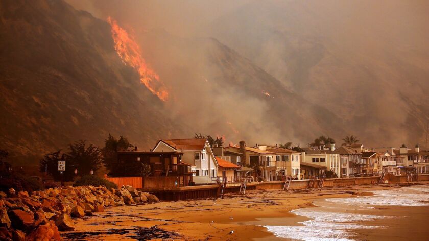 Homes on the Pacific Ocean between Solimar and Faria Beaches North of downtown Ventura as the Thomas Fire burns in the hills on the North side of the 101 freeway.