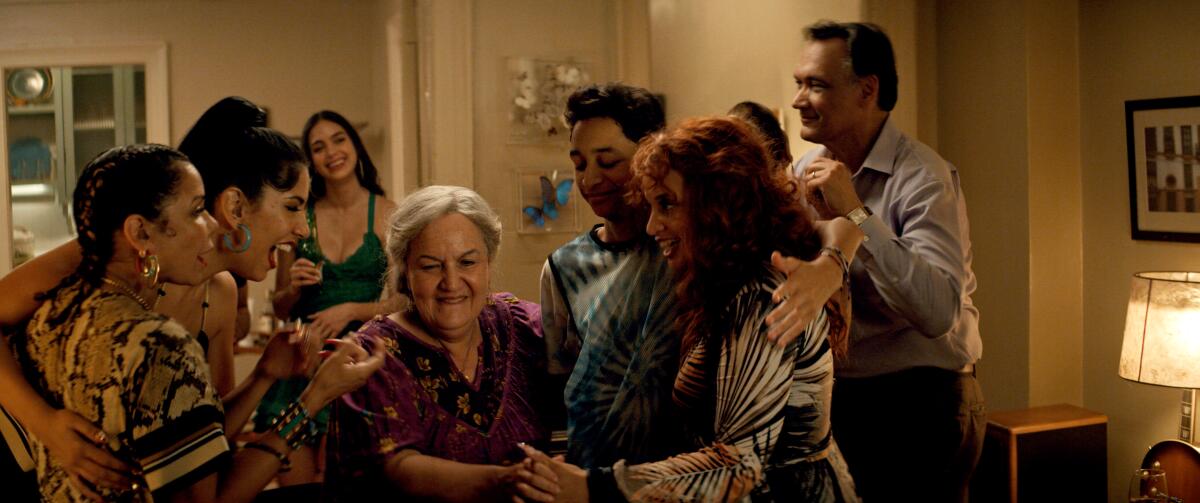 A house party — with Abuela Claudia in the center — gets under way in "In the Heights."