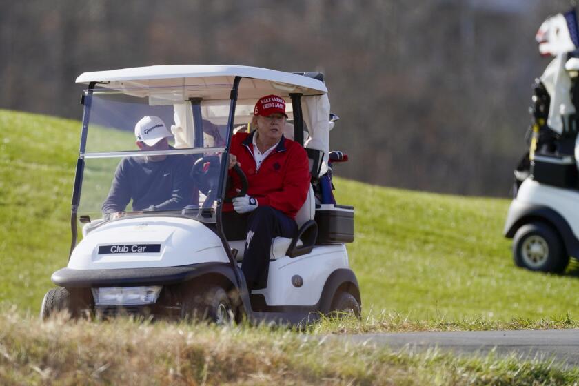 President Donald Trump drives a golf cart as he plays golf at Trump National Golf Club, Saturday, Nov. 28, 2020, in Sterling, Va. (AP Photo/Alex Brandon)