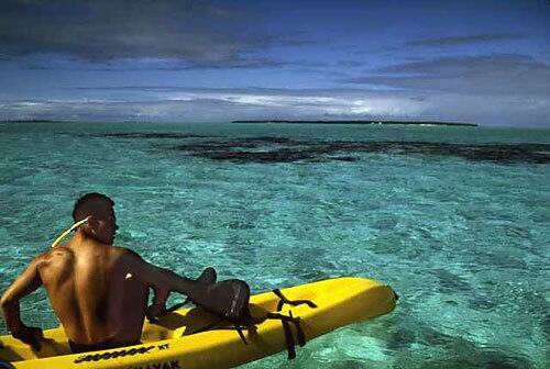 A kayaker heads toward Midway, which is about to open the doors to a small-scale visitor program managed by the U.S. Fish & Wildlife Service. The atoll is part of Northwestern Hawaiian Islands Marine National Monument, dubbed the Hawaiian Galápagos, and was established in 2006 by President Bush.