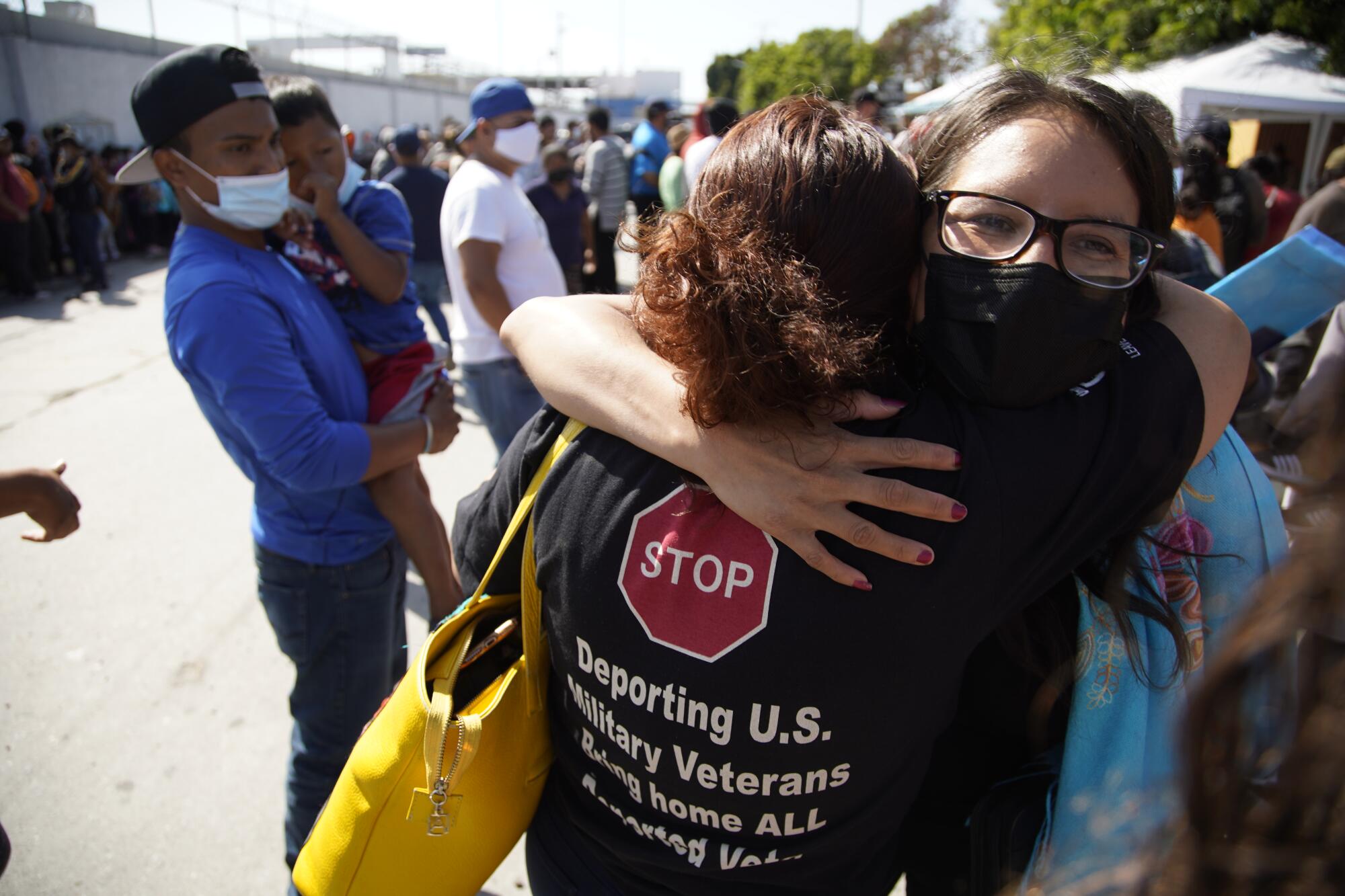 Dulce Garcia hugs Rocio Rebollar Gomez standing in the street