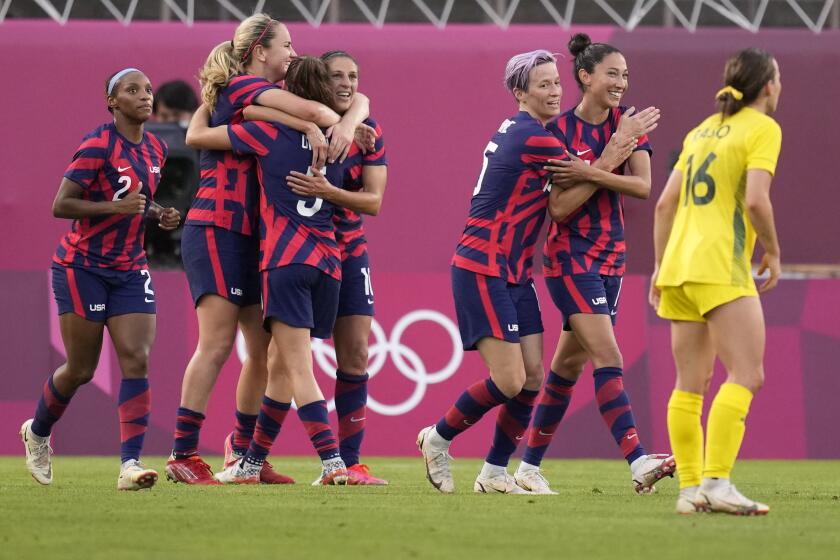 United States' Carli Lloyd, center, celebrates scoring her side's 4th goal against Australia with teammates during the women's bronze medal soccer match at the 2020 Summer Olympics, Thursday, Aug. 5, 2021, in Kashima, Japan. (AP Photo/Andre Penner)