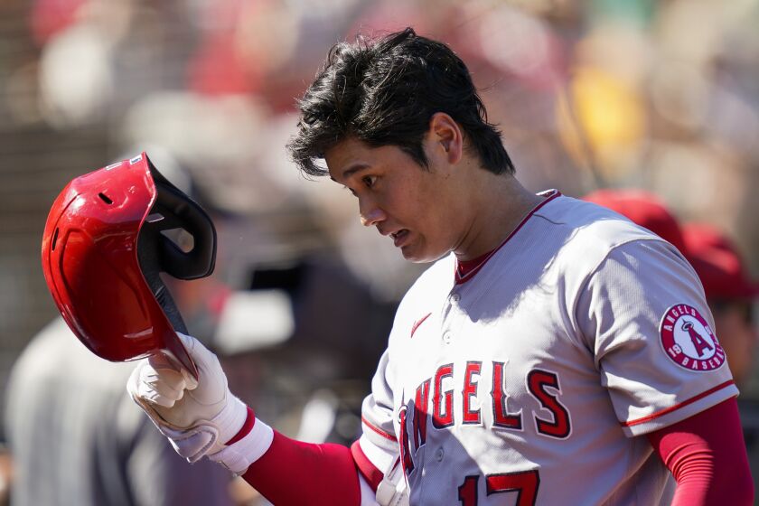 Los Angeles Angels' Shohei Ohtani walks to the dugout after pitching against the Oakland Athletics during the fifth inning of a baseball game in Oakland, Calif., Wednesday, Oct. 5, 2022. (AP Photo/Godofredo A. Vásquez)