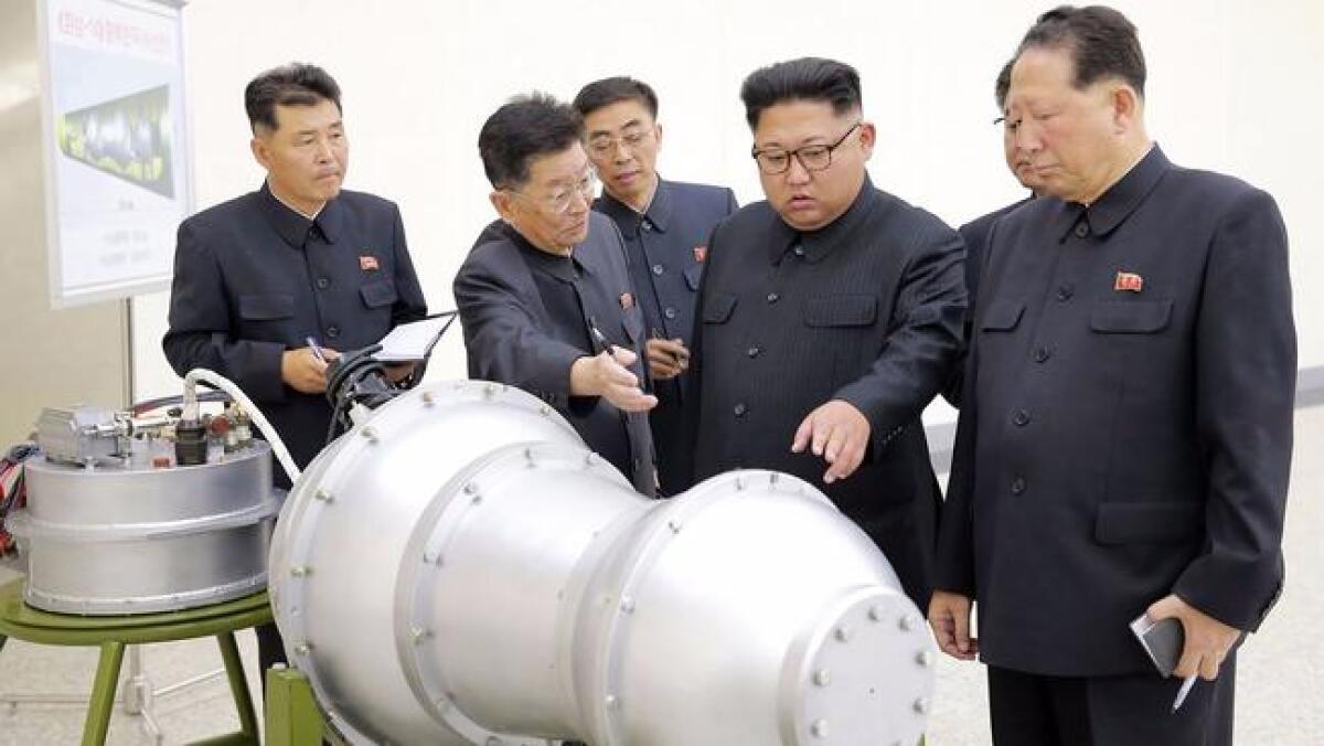 North Korean leader Kim Jong Un views device in undated photo released by state news agency.