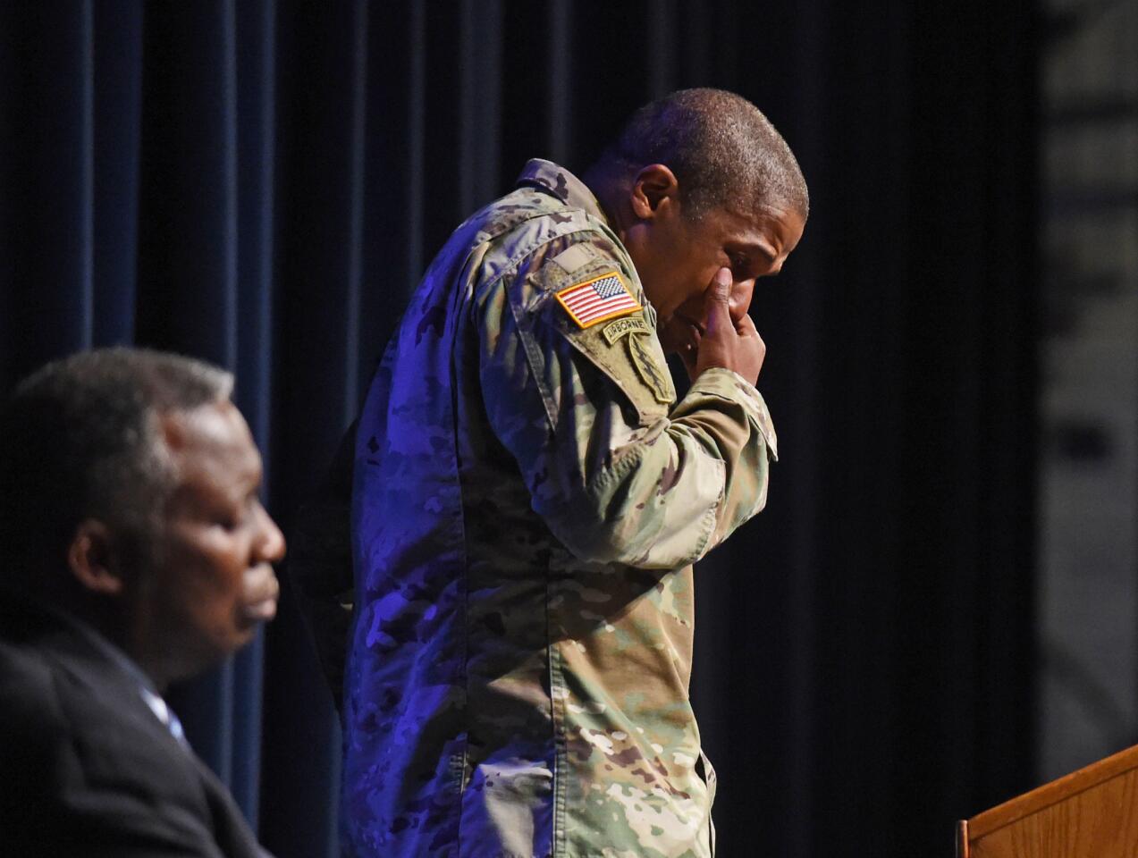Lt. Col. Joel Thomas, professor of military sciences, wipes tears while memorializing Richard Collins III.