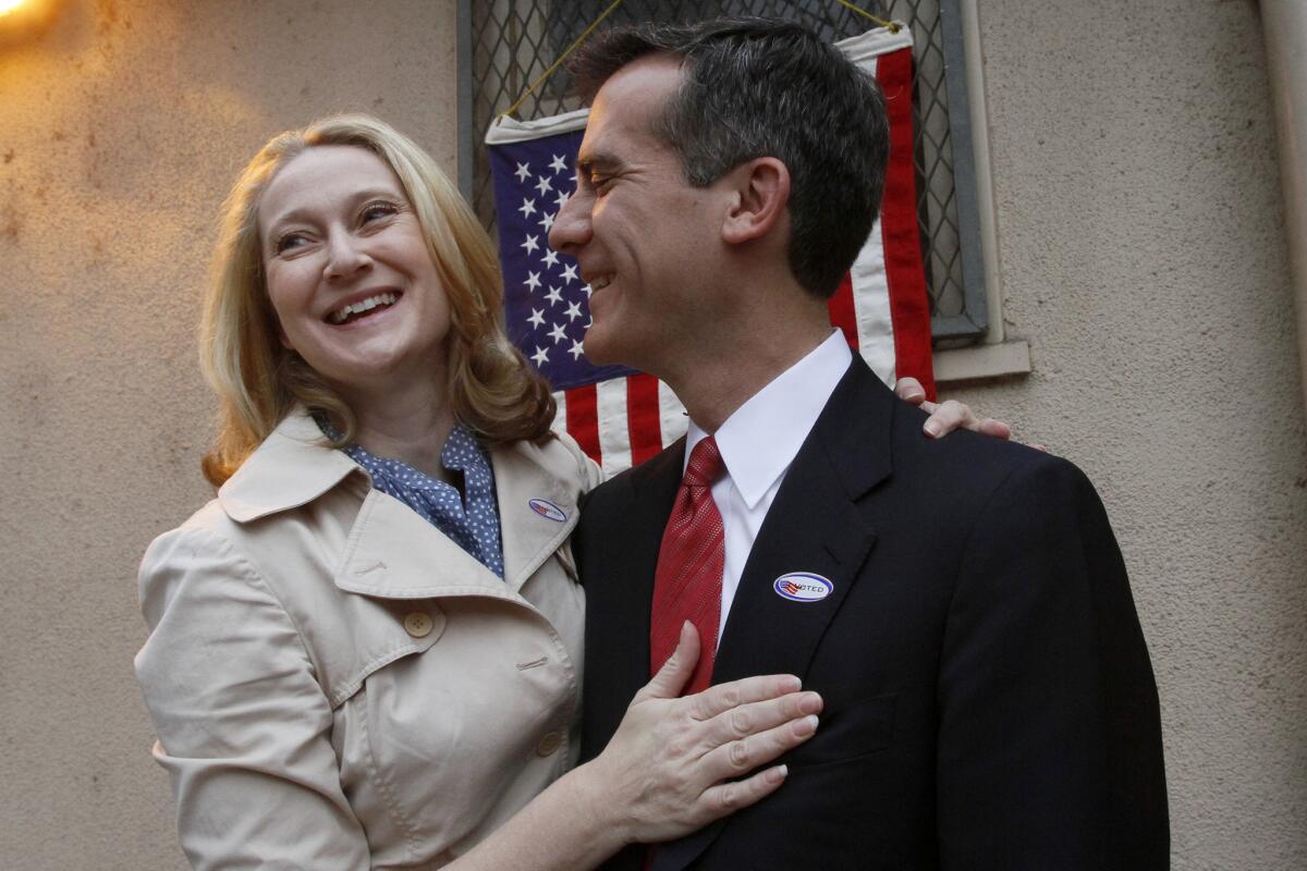 Mayor Eric Garcetti and his wife, Amy Wakeland, shown in 2013, announced a drive Wednesday to help replace holiday gifts destroyed in a massive fire that struck a downtown Los Angeles construction site Monday night.