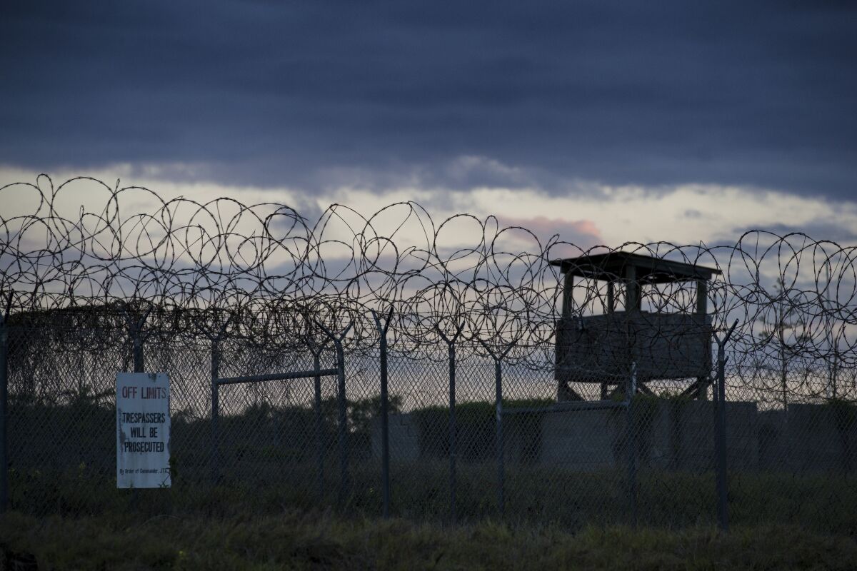 FILE - In this photo reviewed by U.S. military officials, the sun sets behind the closed Camp X-Ray detention facility, on April 17, 2019, in Guantanamo Bay Naval Base, Cuba. The Biden administration has been quietly laying the groundwork to release prisoners from the Guantanamo Bay detention center and at least move closer to being able to shut it down. (AP Photo/Alex Brandon, File)