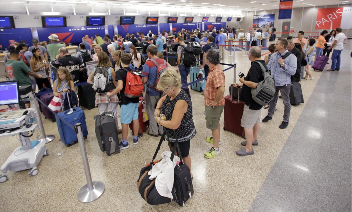 Delta Air Lines passengers stand in line in Salt Lake City, Utah, after flights resumed Monday following the airline's computer outage that canceled and delayed hundreds of flights.