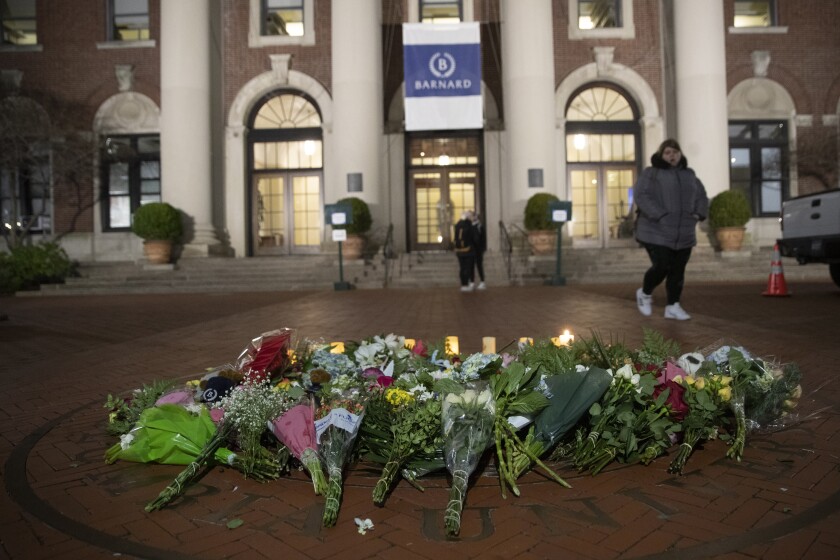 A woman walks past a makeshift memorial for Tessa Majors on the Barnard College campus in New York.
