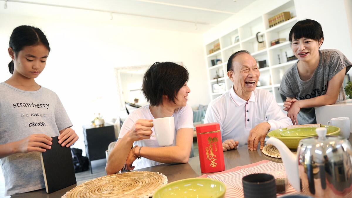 Architect Yuwen Peng, second from left, enjoys a cup of tea at home in Venice with her niece Claire, her father, Fuyung, and her sister Vivian.